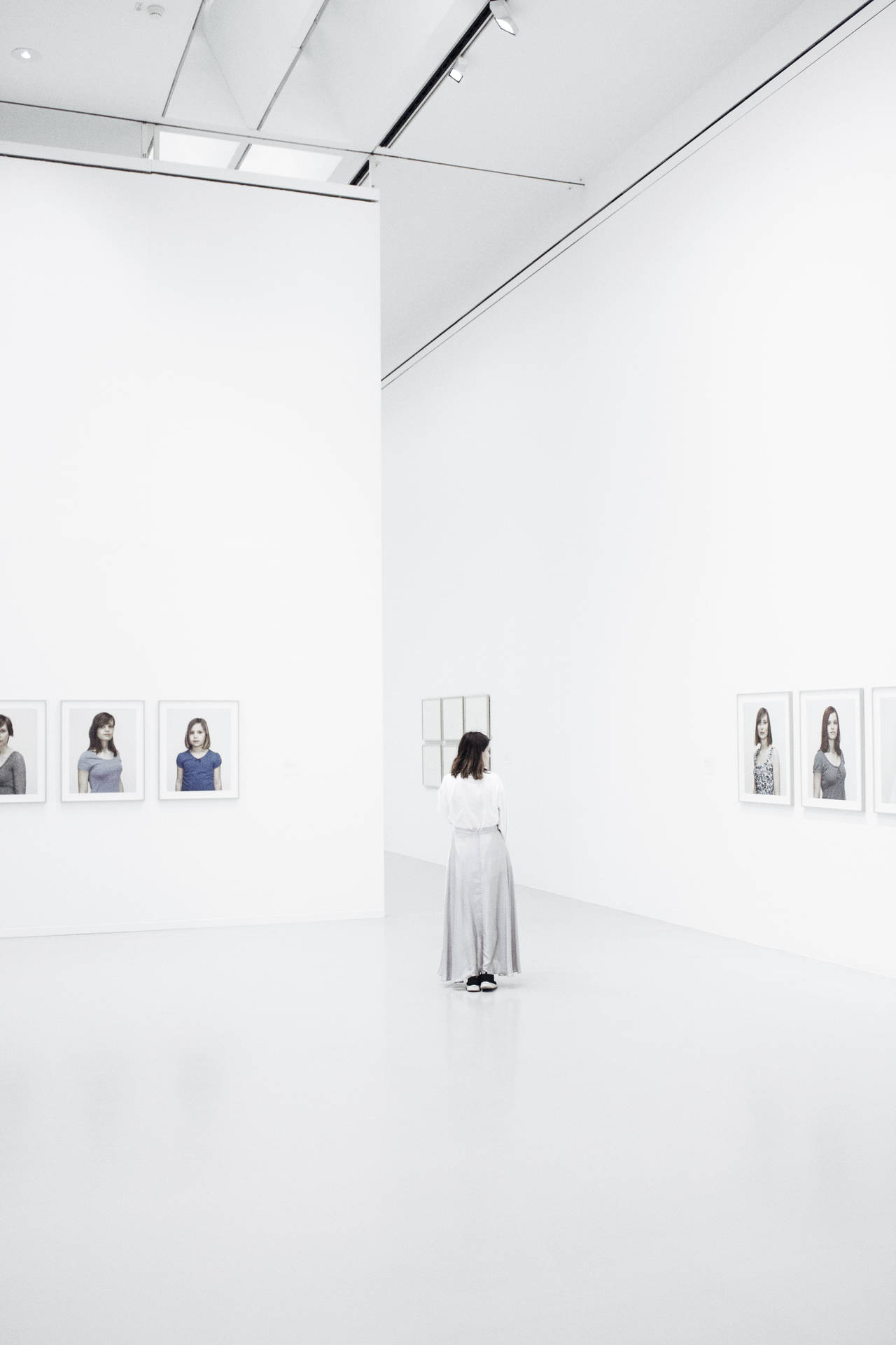 Woman Inside A Bright White Gallery
