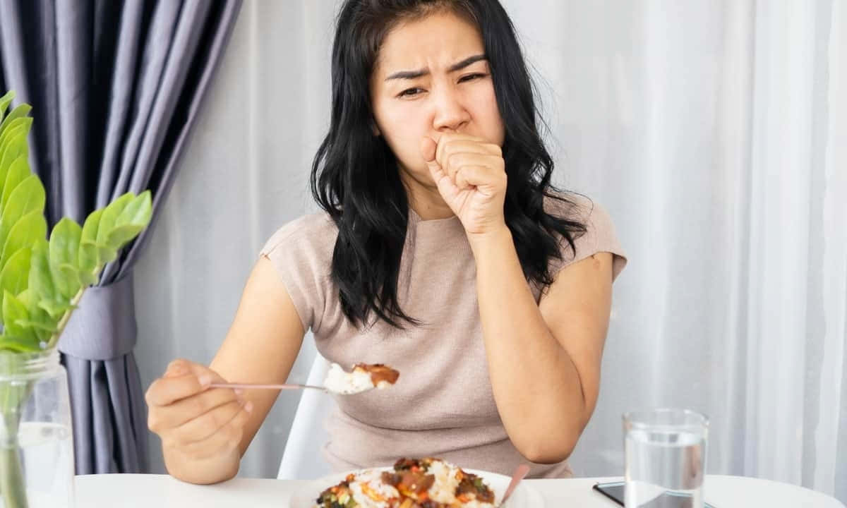 Woman Looking Nauseous While Eating Wallpaper