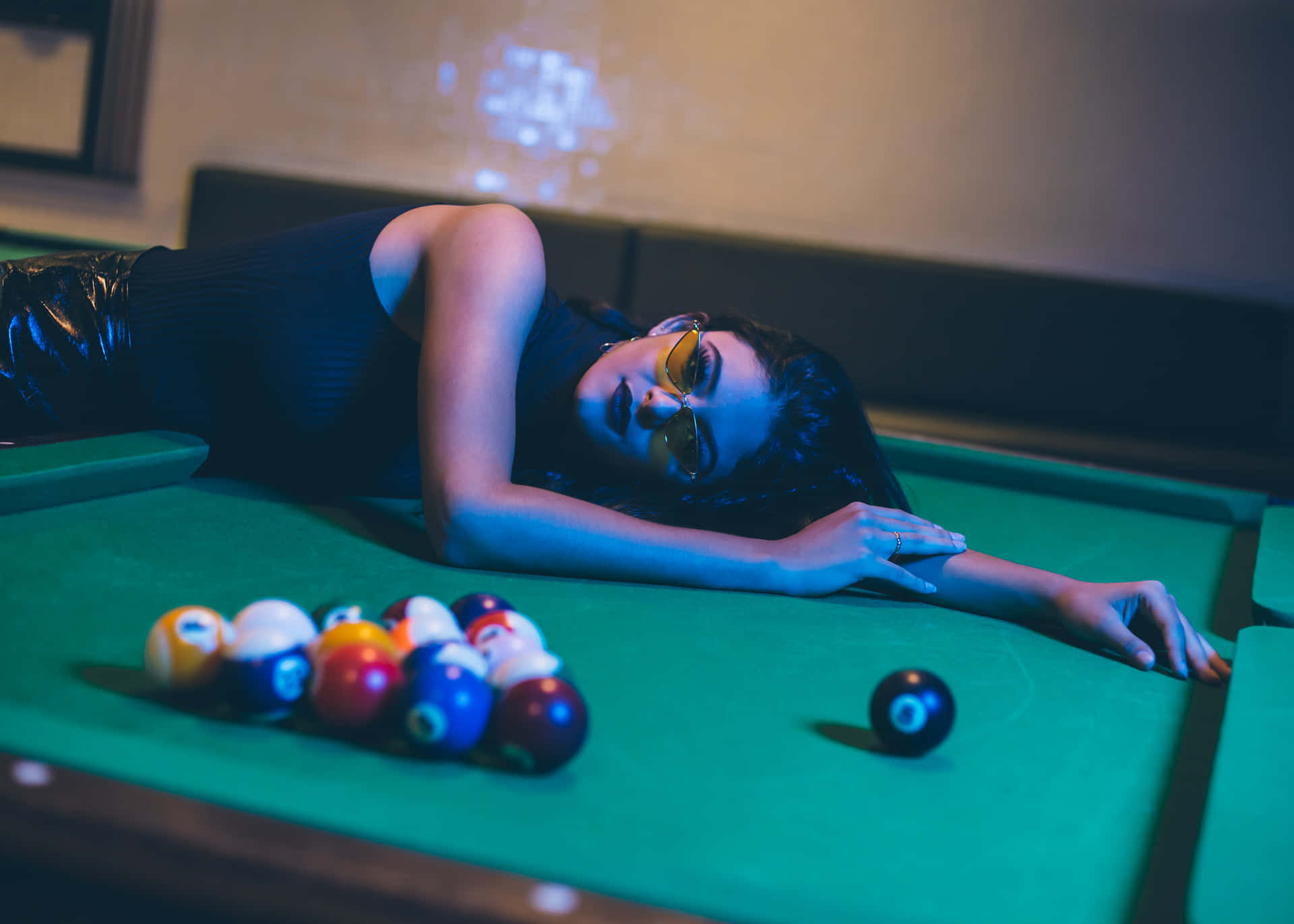 Artistic Image of a Woman Lounging on a Pool Table Wallpaper