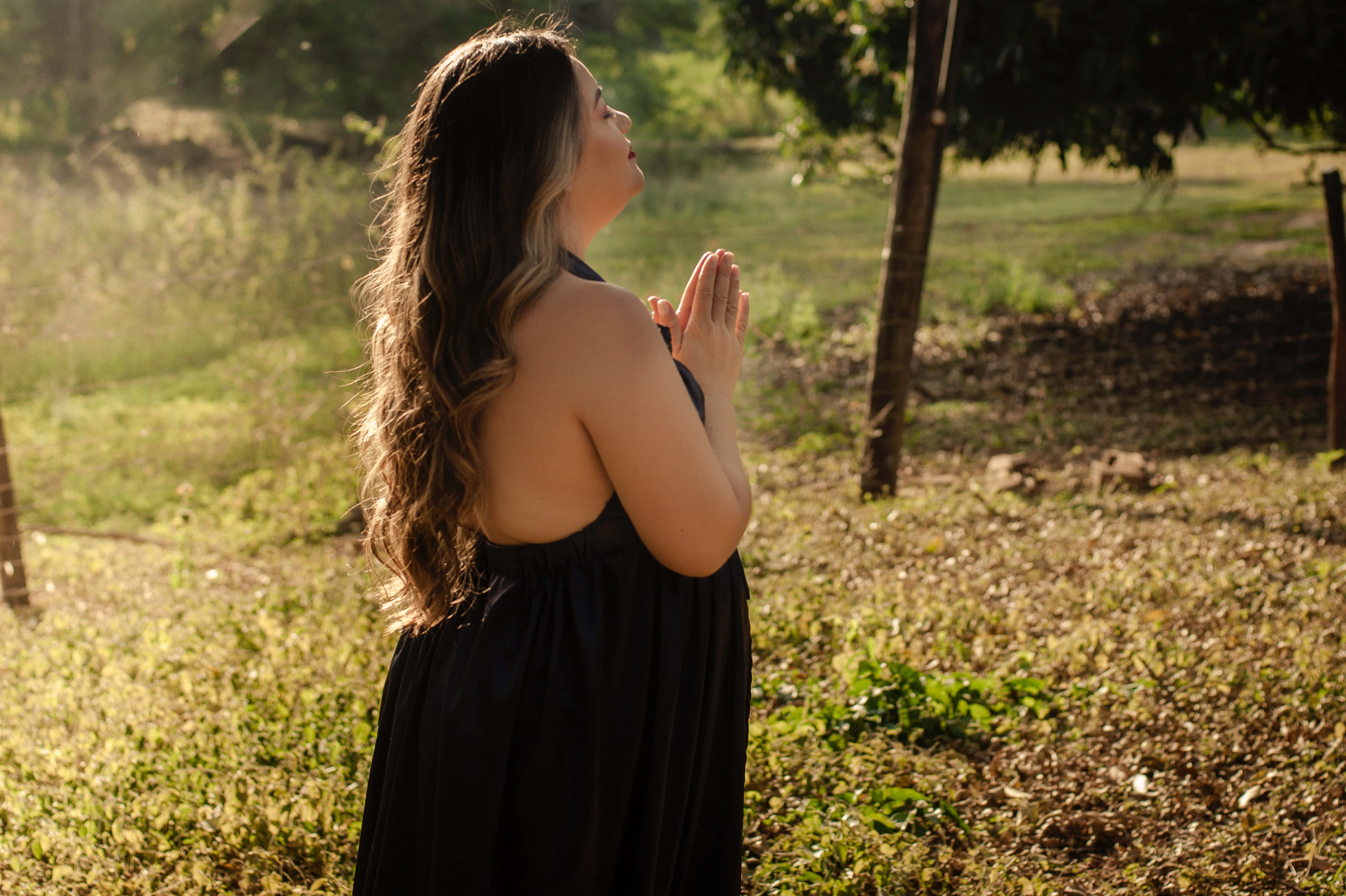 Woman Praying In A Black Dress Wallpaper