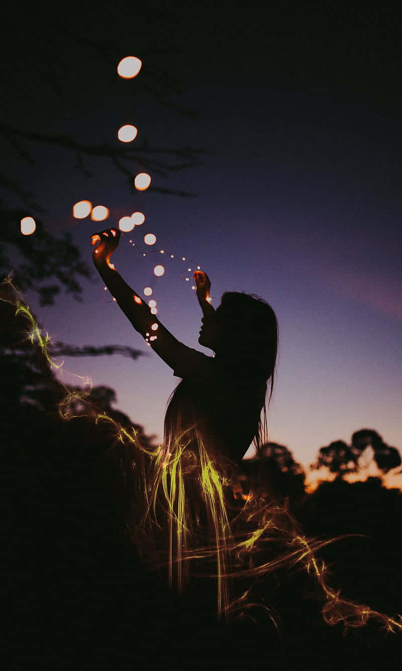 Download Woman Setting Up Fairy Lights During Evening Wallpaper ...