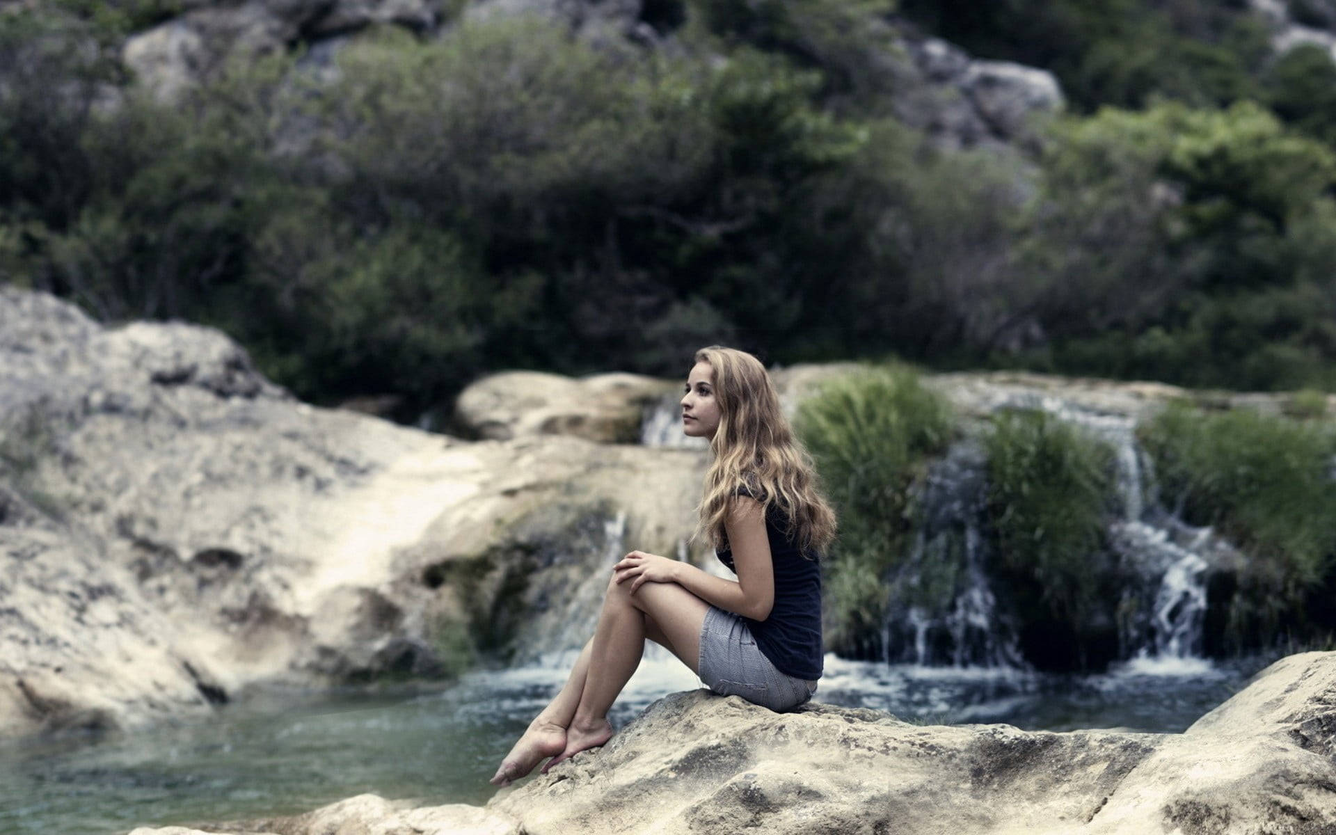 Woman Sitting Alone By The River Wallpaper