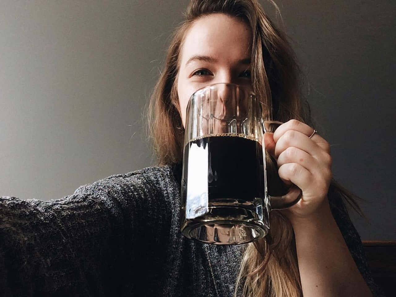 Woman Smiling With Coffee Mug Wallpaper