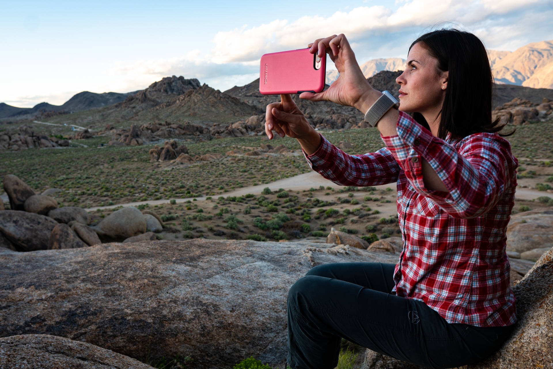 Woman taking landscape photo with her smartphone wallpaper.