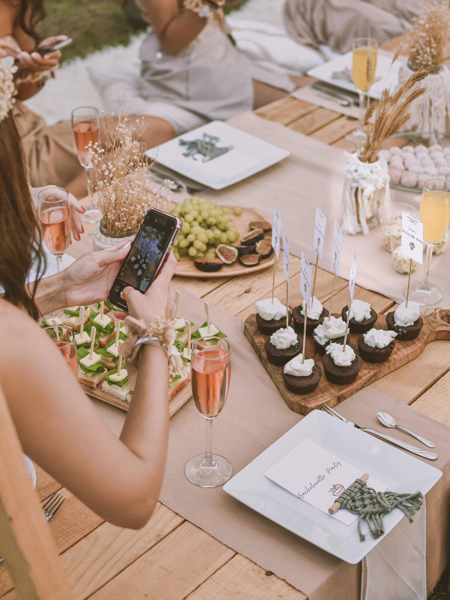 Woman Taking Photo Of Bachelorette Party Food