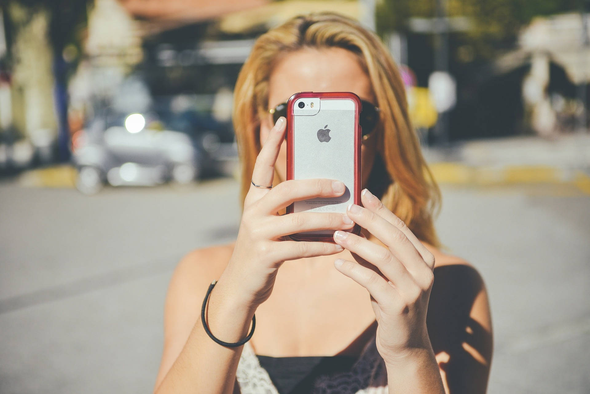 Woman Taking Photo Using Mobile Phone Wallpaper