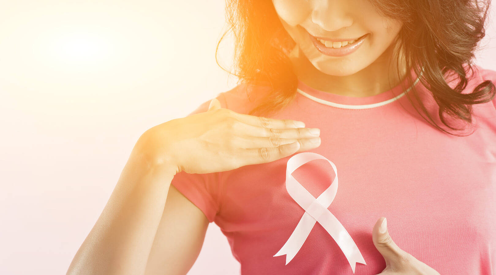 Strength and Awareness - Woman Embracing Breast Cancer Ribbon Wallpaper