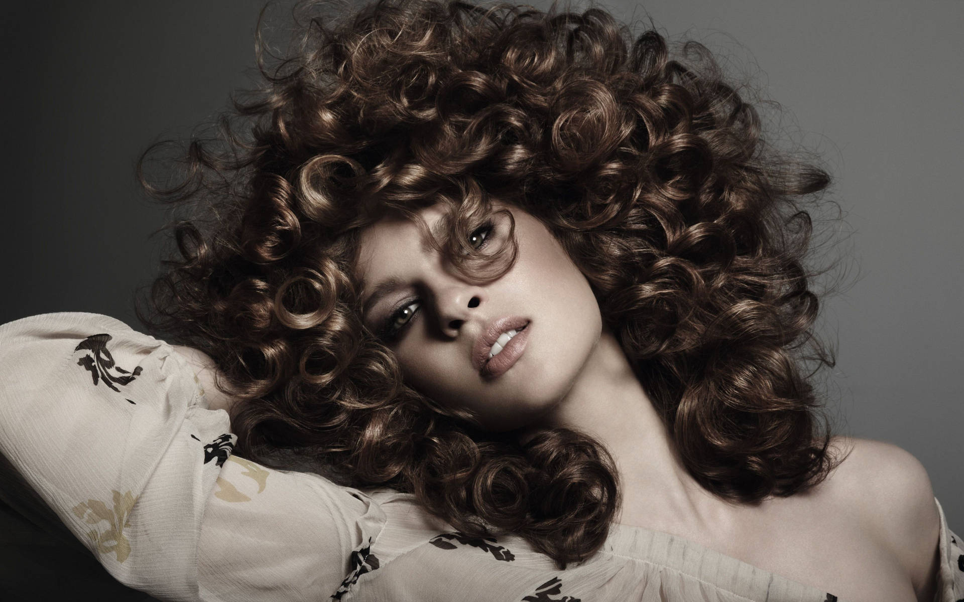 Embrace the Curl — Woman Flaunting Her Luscious Curly Hair. Wallpaper