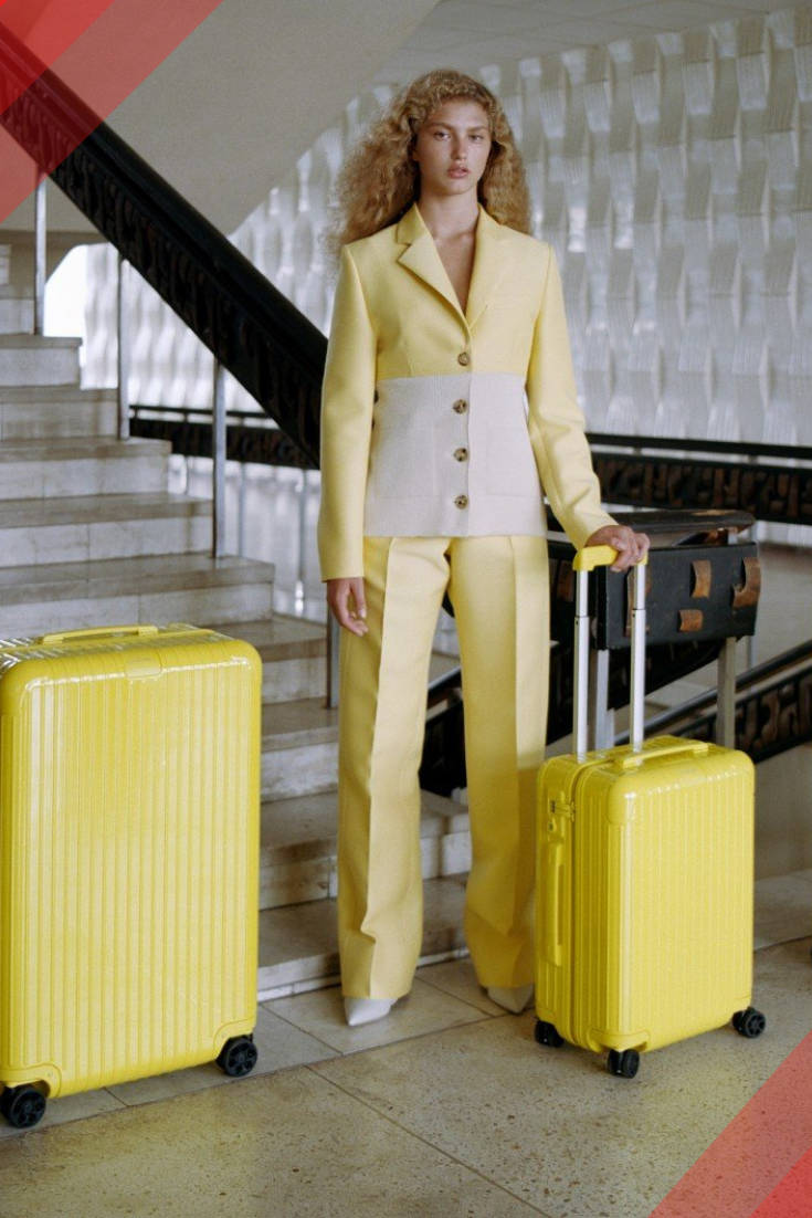 Woman With Two Rimowa Suitcases Wallpaper