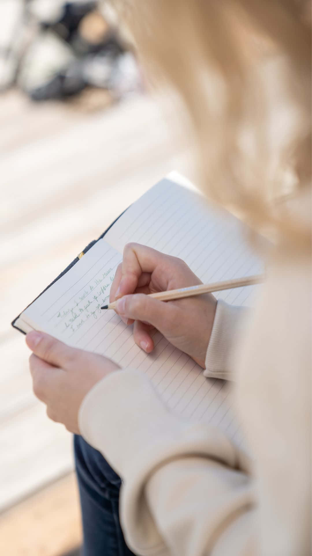 Woman Writingin Notebook Outdoors Wallpaper