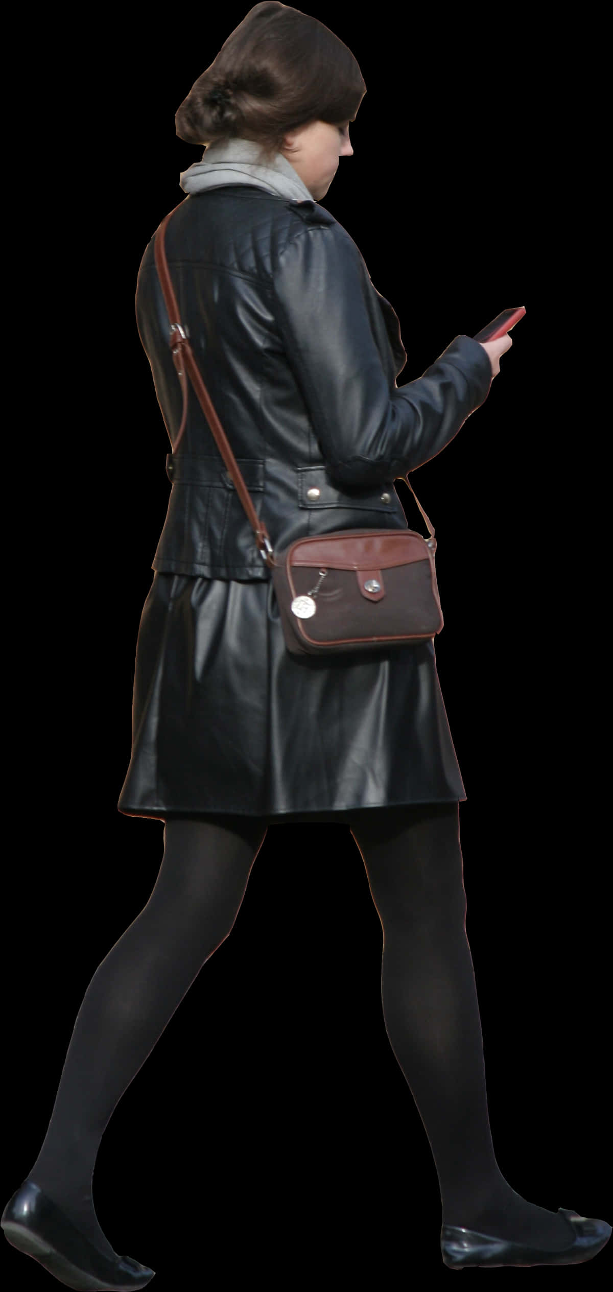 Womanin Leather Coat Walkingand Texting PNG