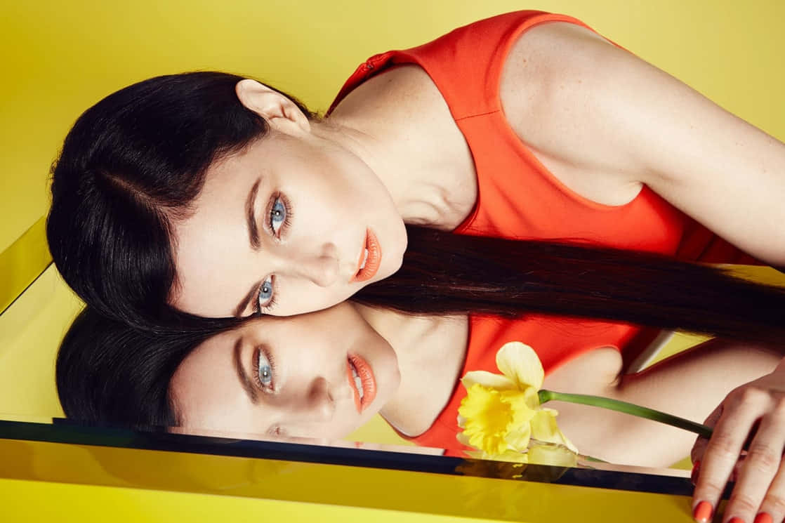 Womanin Redwith Reflectionand Yellow Flower Wallpaper