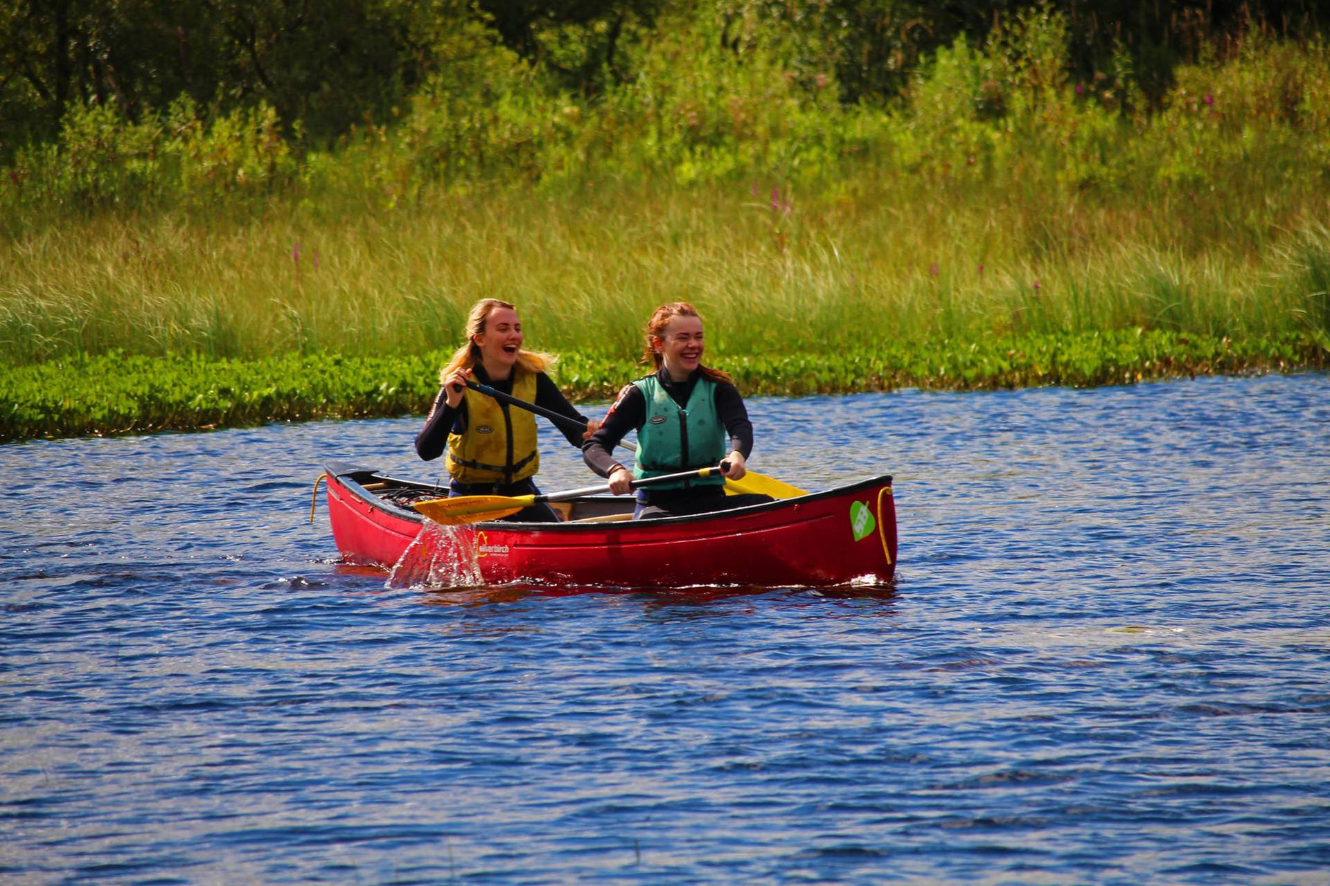 Women Canoeing Together Wallpaper