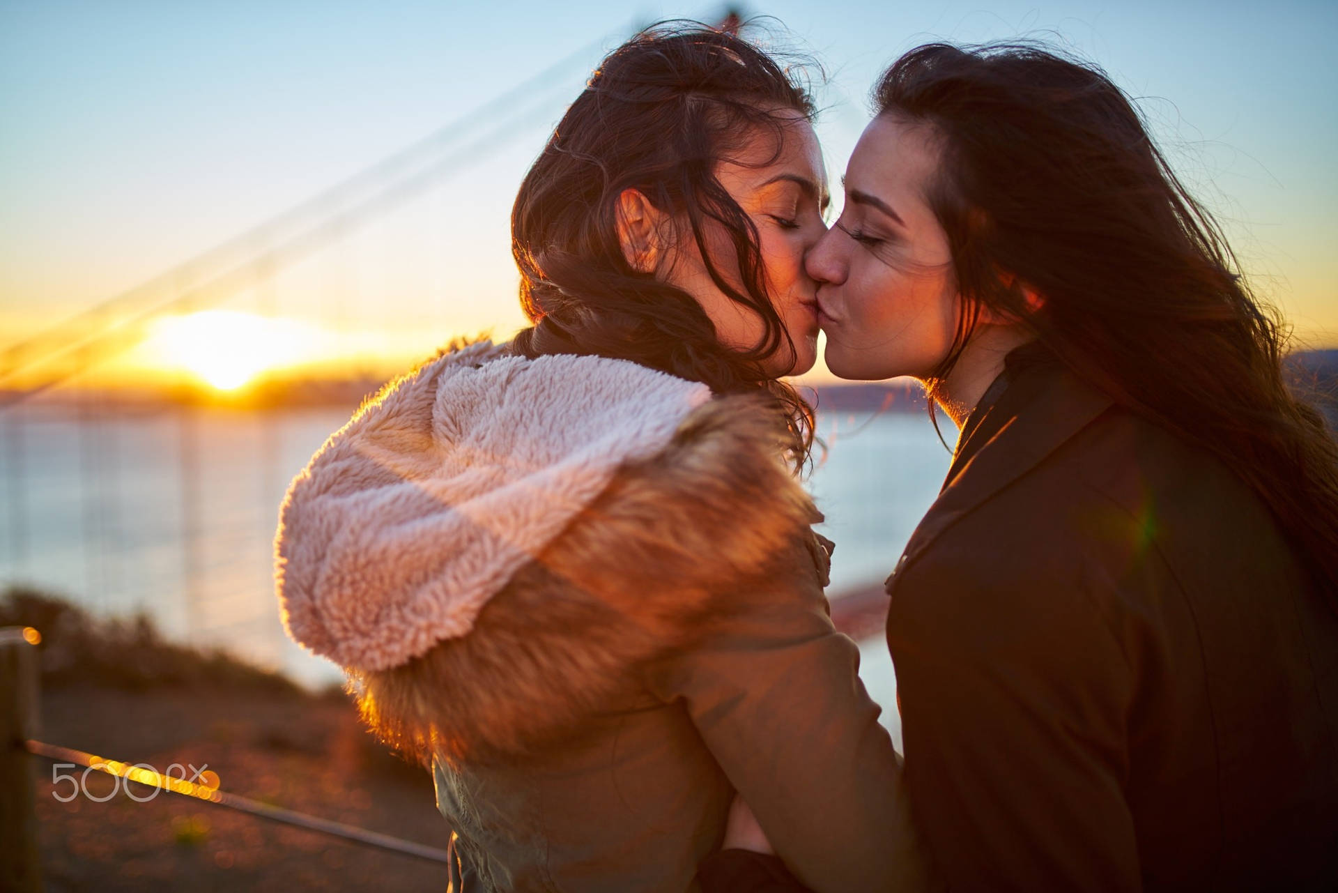 Women Kissing Near Sea Wallpaper