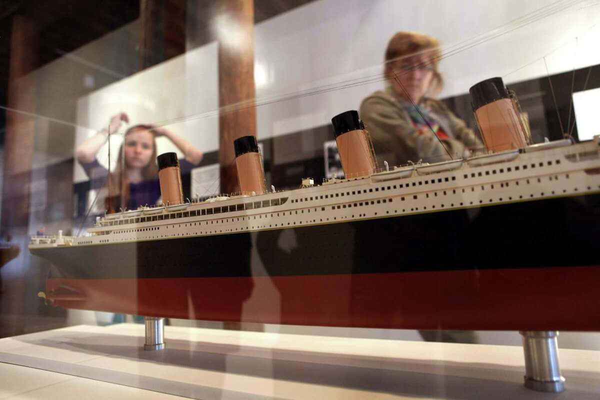 Women Looking At Rms Titanic Museum Model Background