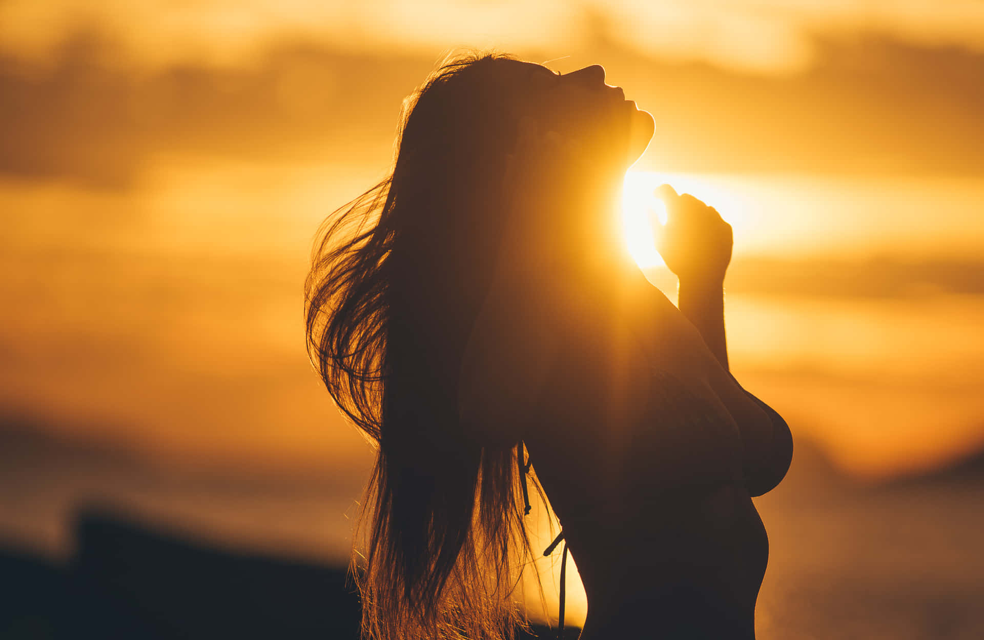 A Woman With Long Hair Standing In The Sun