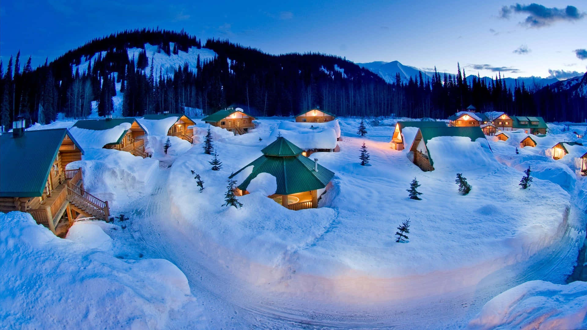 A Group Of Cabins In The Snow