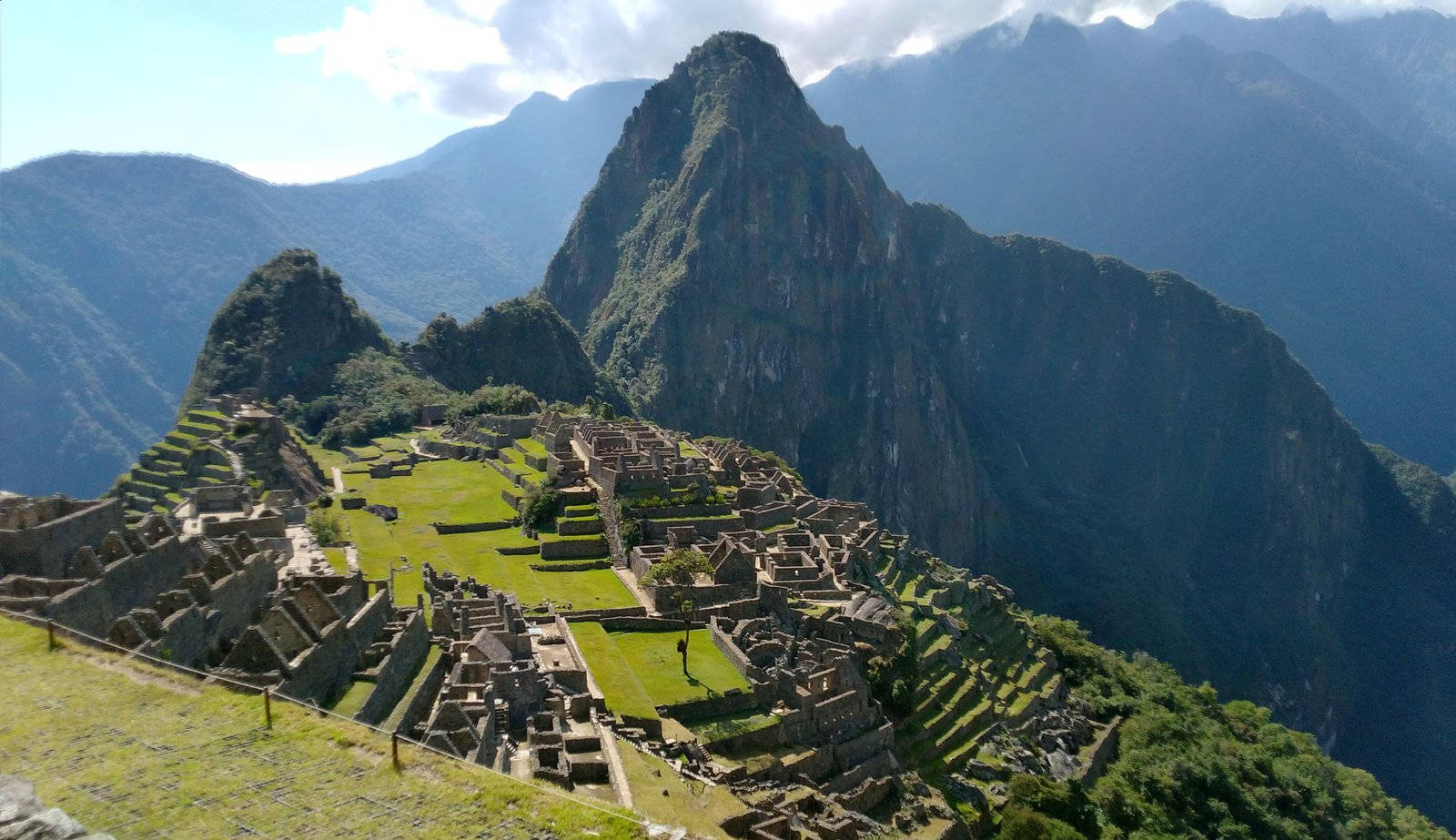 Caption: Majestic View of the Ancient Incan City, Machu Picchu Wallpaper