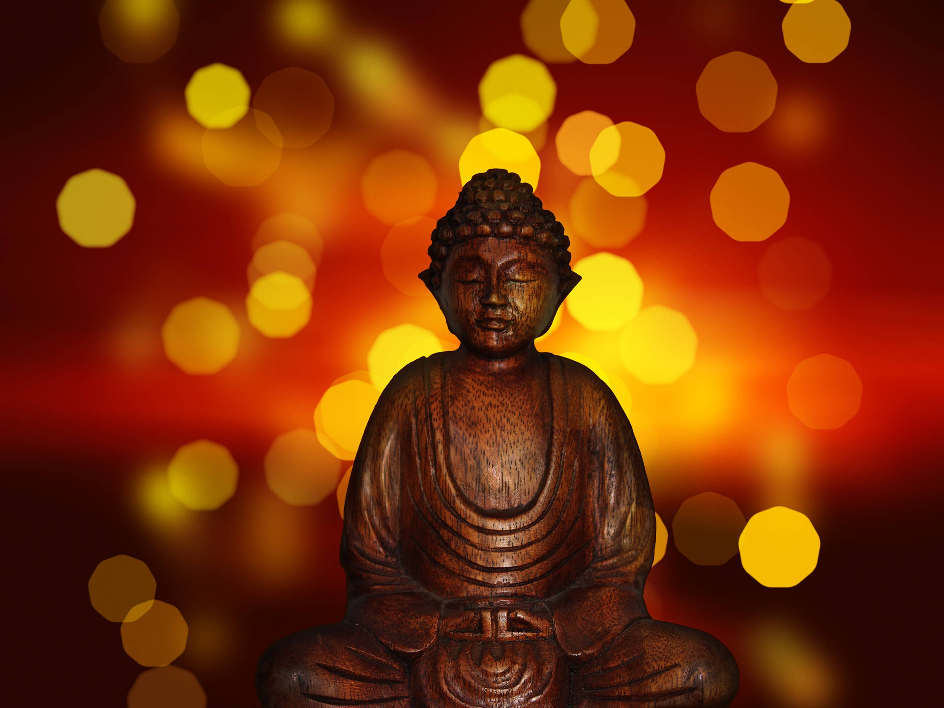 A wooden Buddha Statue surrounded by an ethereal setting. Wallpaper