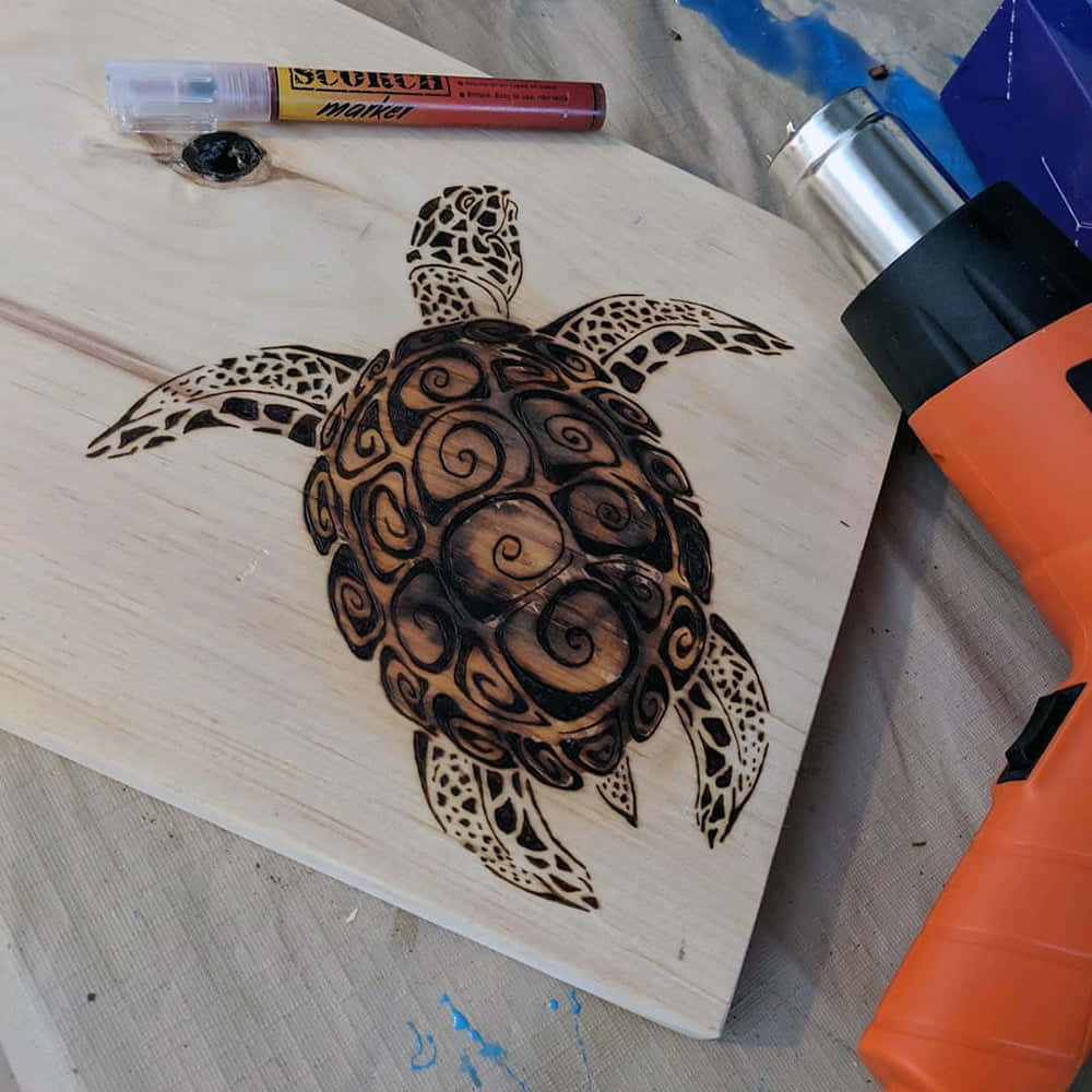 A Wooden Board With A Turtle Design And A Drill
