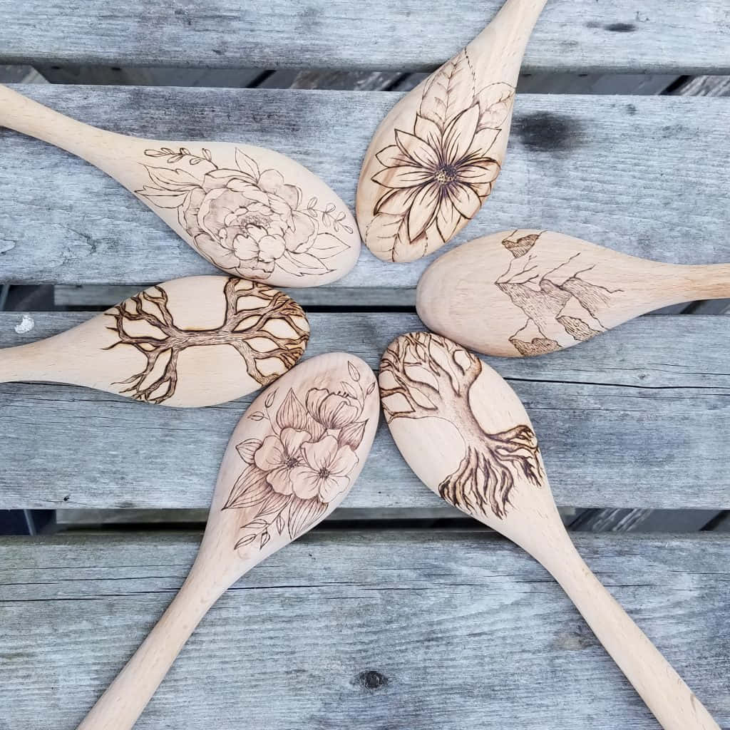 Five Wooden Spoons With Designs On Them