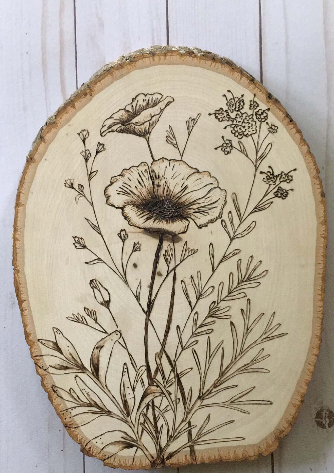 A Wood Slice With A Drawing Of Flowers