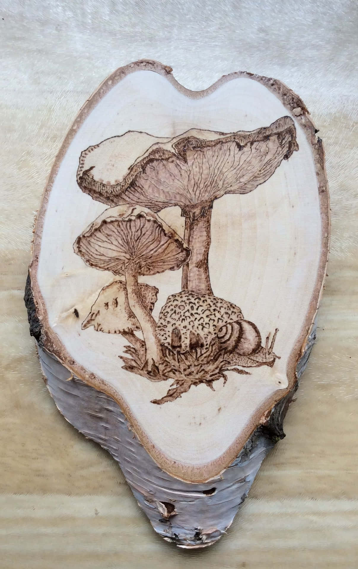 A Piece Of Wood With A Mushroom Carving On It