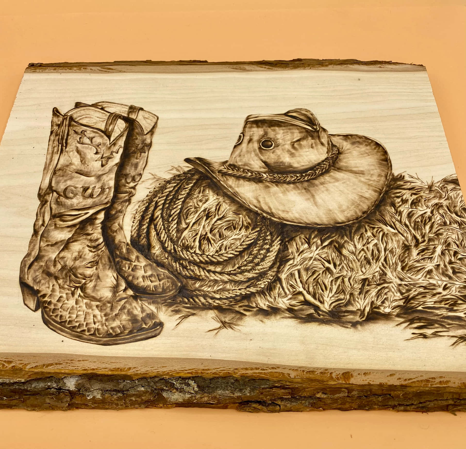 A Wooden Cutting Board With A Cowboy Hat And Boots