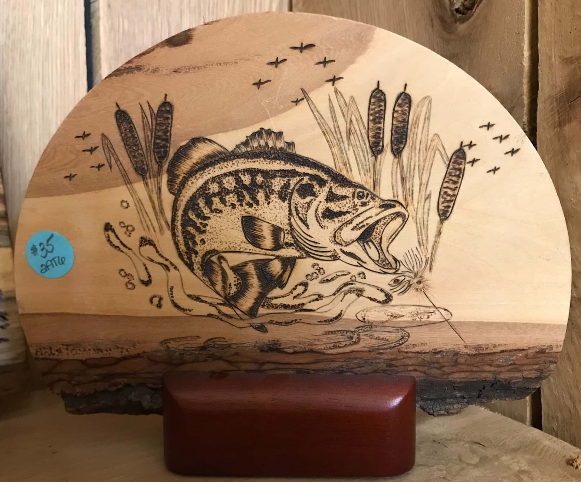 A Wooden Plaque With A Fish On It