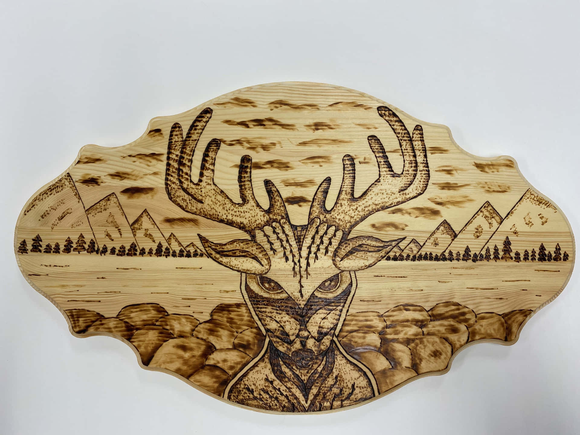 A Wooden Plaque With A Deer Head On It