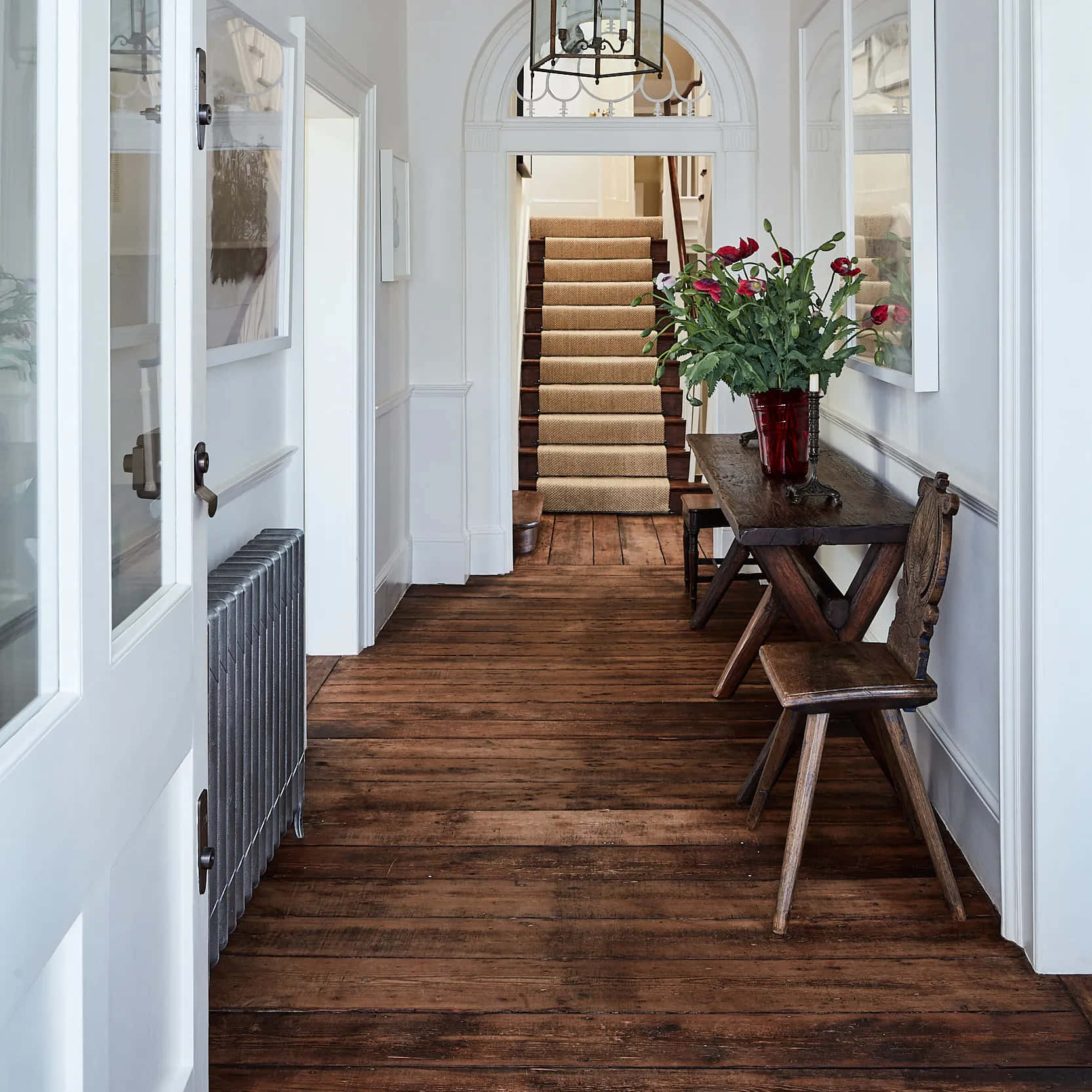 A Hallway With Wooden Floors And A Staircase