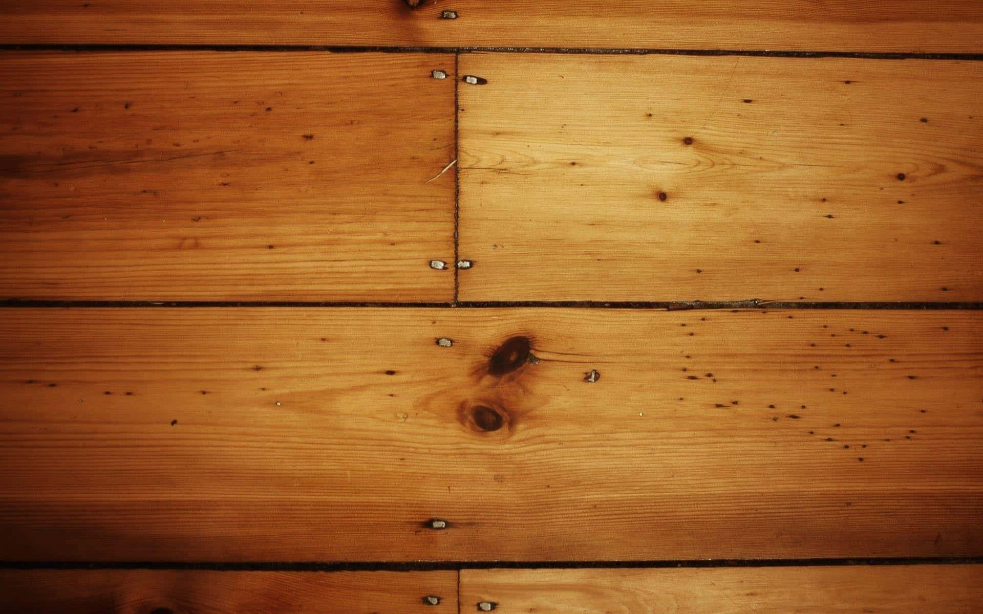 A Wooden Floor With Nails On It
