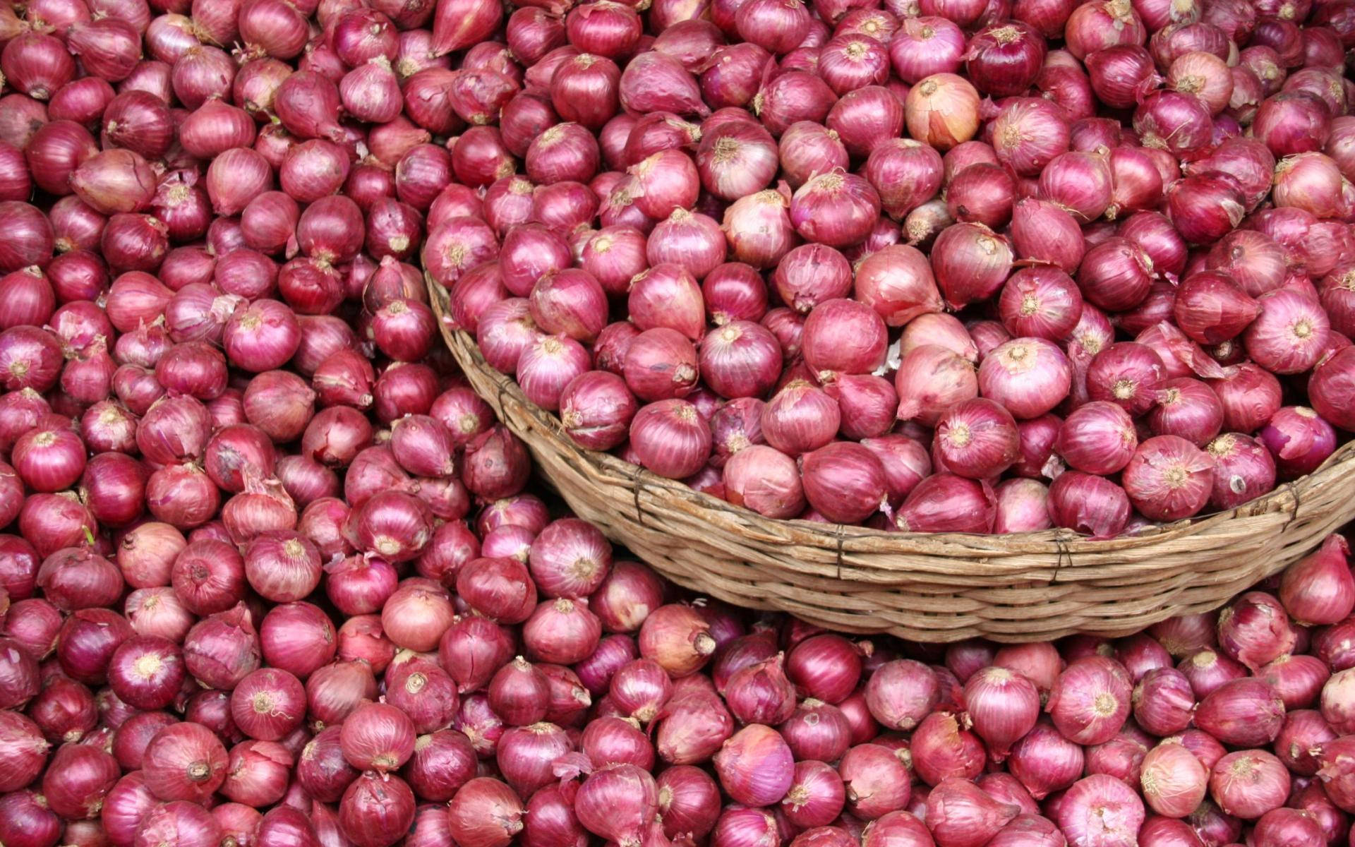 Wooden Basket Overflowing With Red Onions Wallpaper