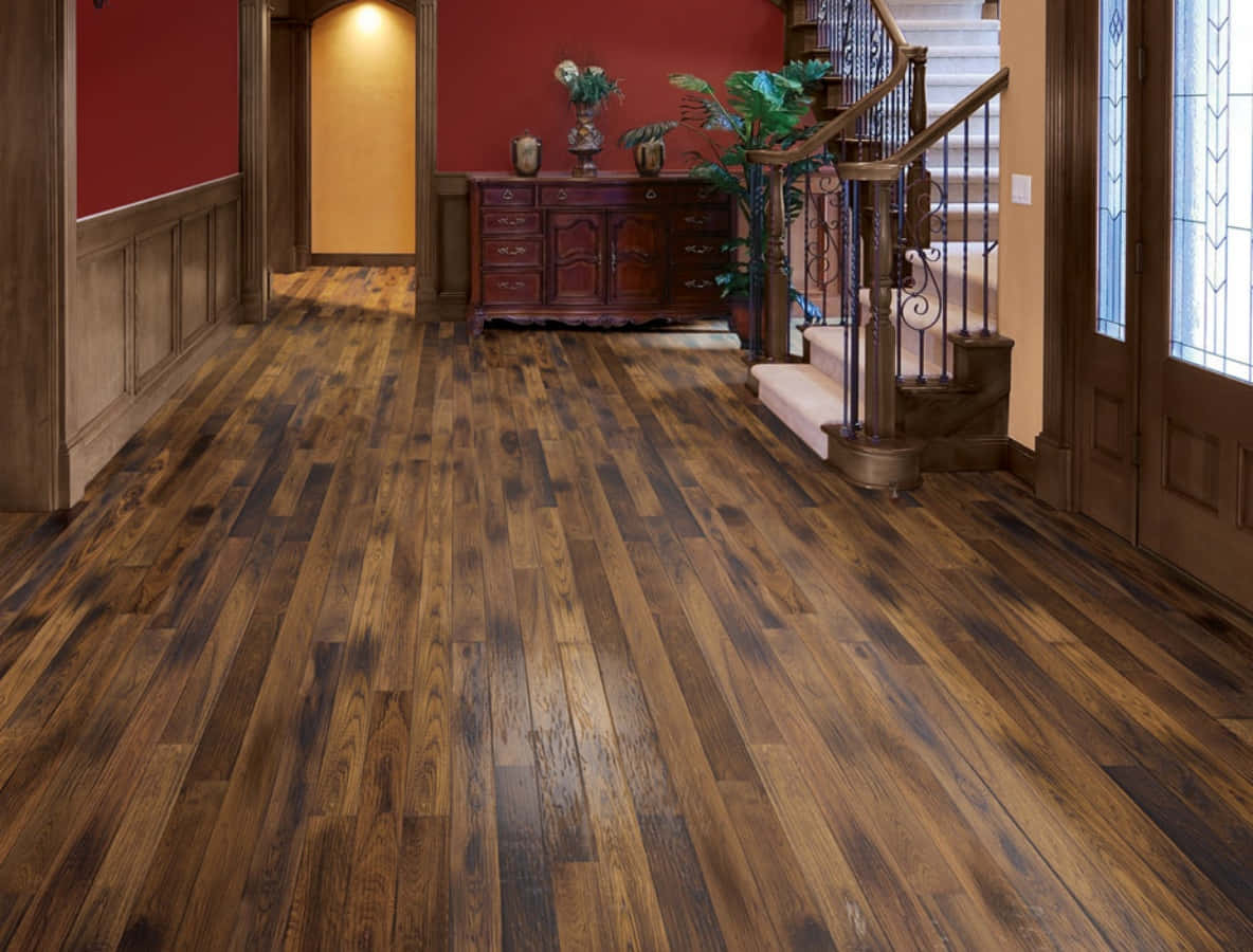 A Hallway With Wood Floors And Red Walls