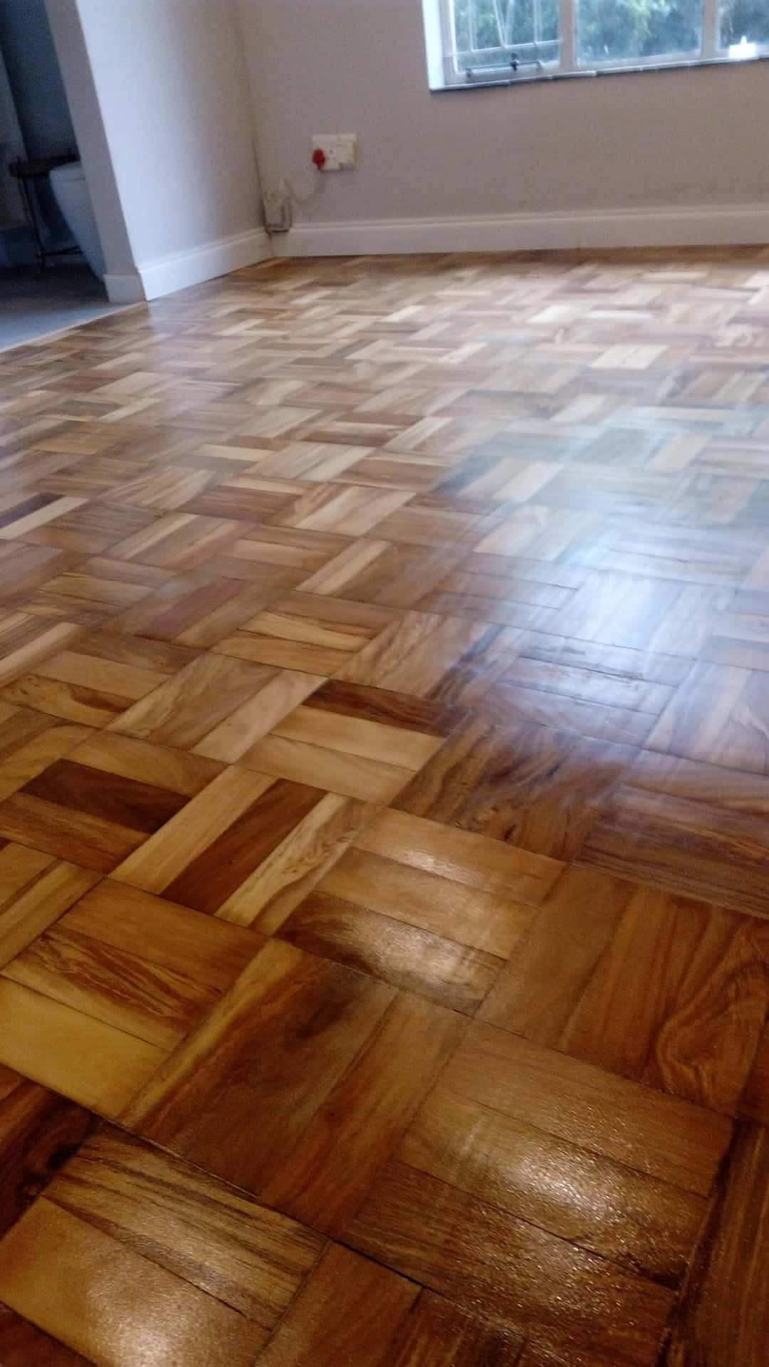A Room With A Wooden Floor That Has Been Cleaned