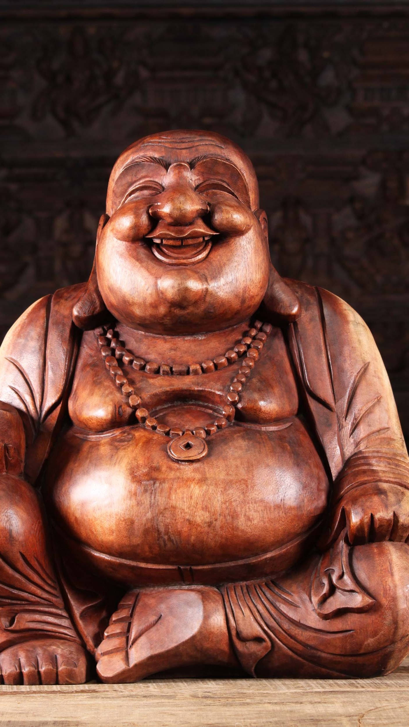 Caption: "Enigmatic Wooden Laughing Buddha Statue" Wallpaper
