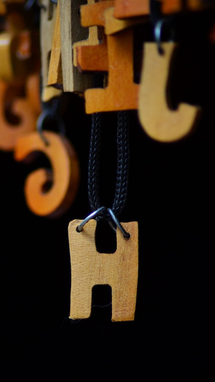 Elegant Wooden Letter H Necklace Wallpaper