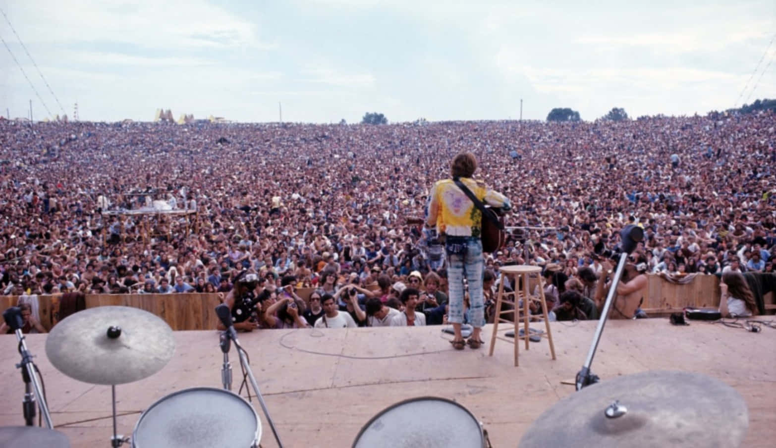 A peaceful field of flowers and a clear blue sky encapsulate the essence of Woodstock