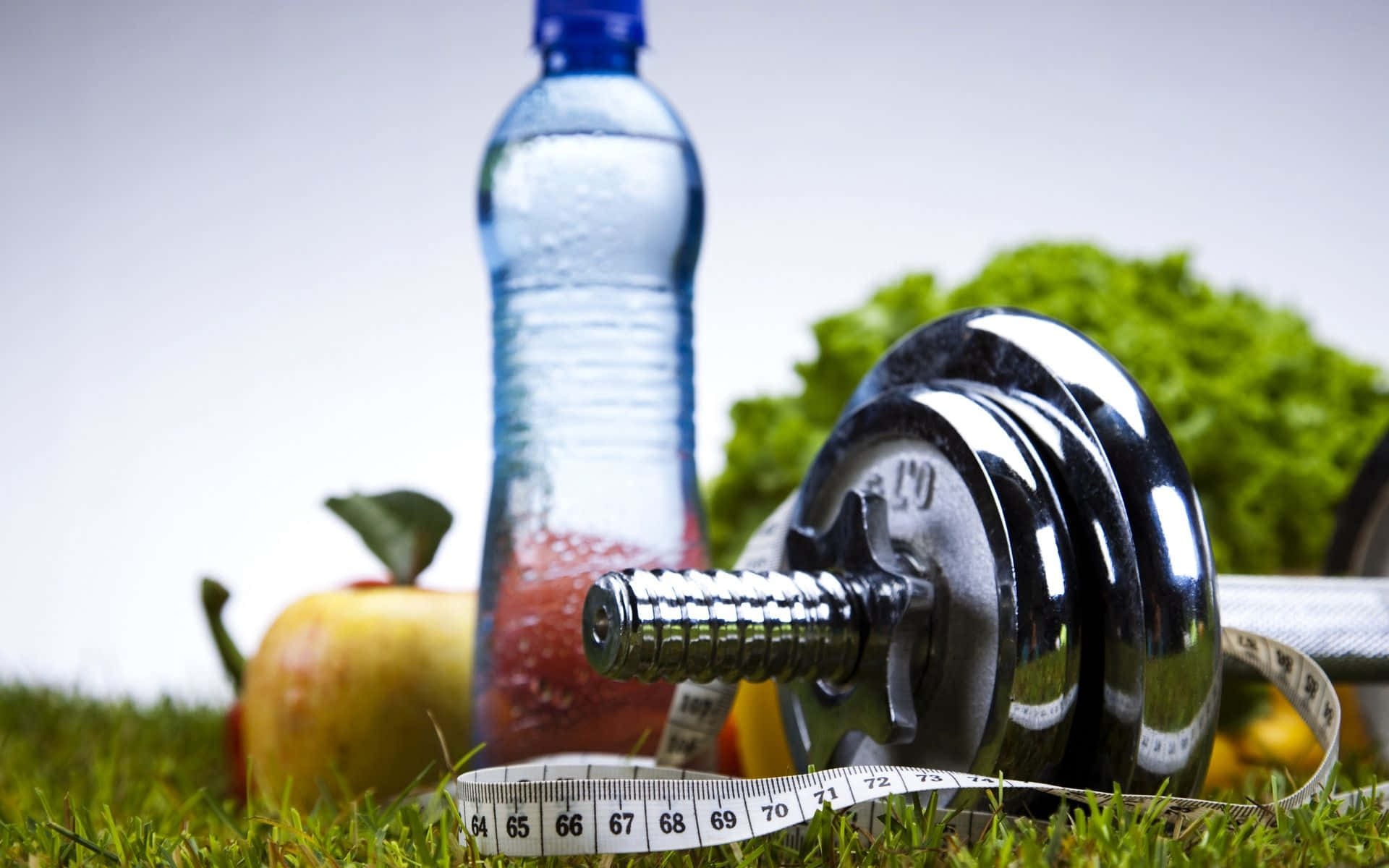 A Bottle Of Water, A Dumbbell And Some Fruit