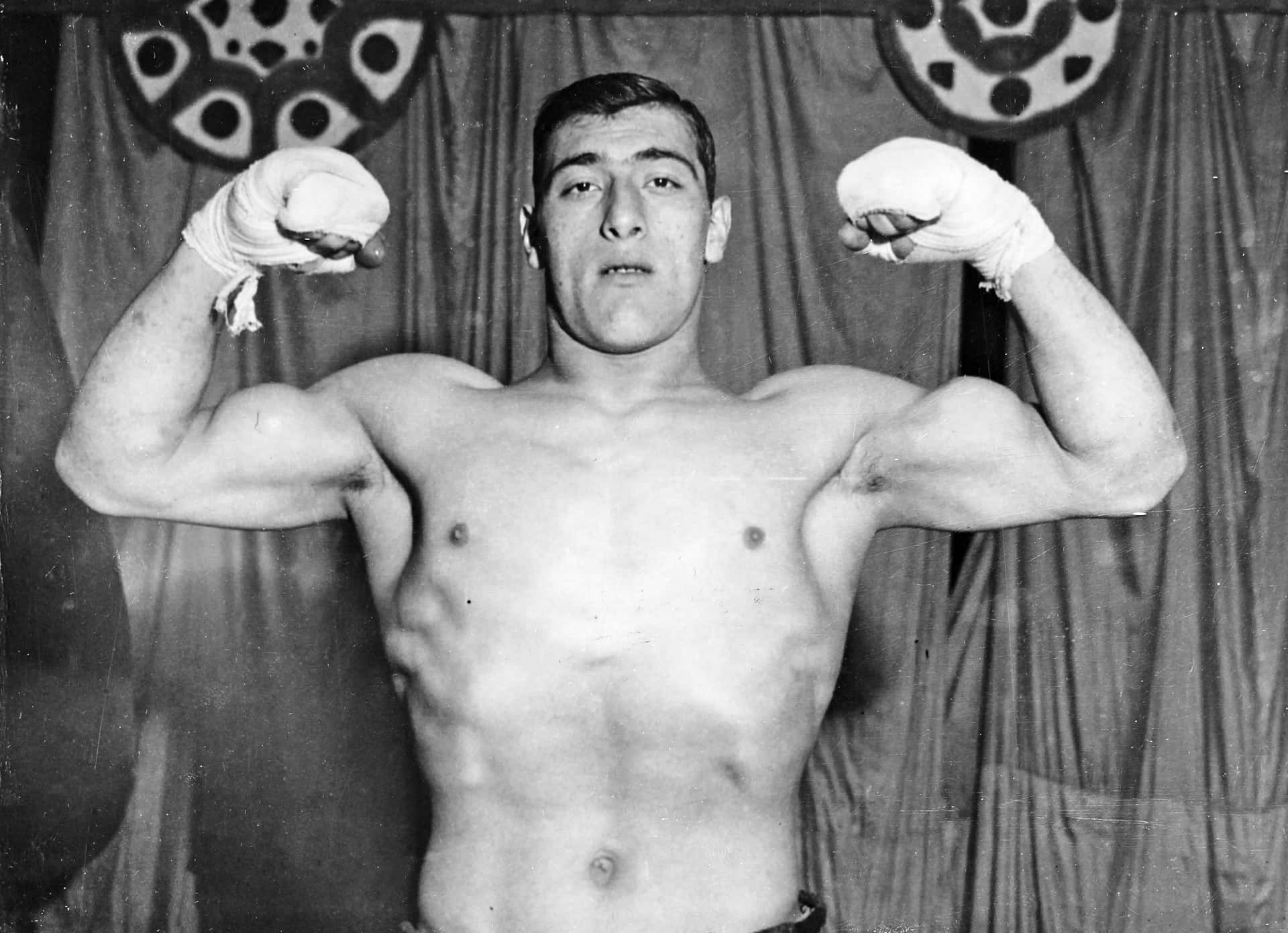World Heavyweight Boxing Champion Primo Carnera Flexing Muscles Background
