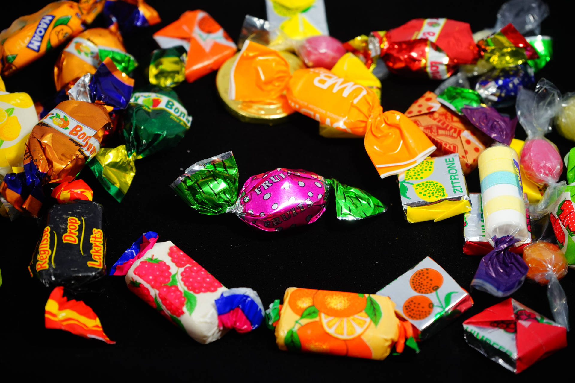 Colorful Assortment of Wrapped Chewy Candies Wallpaper