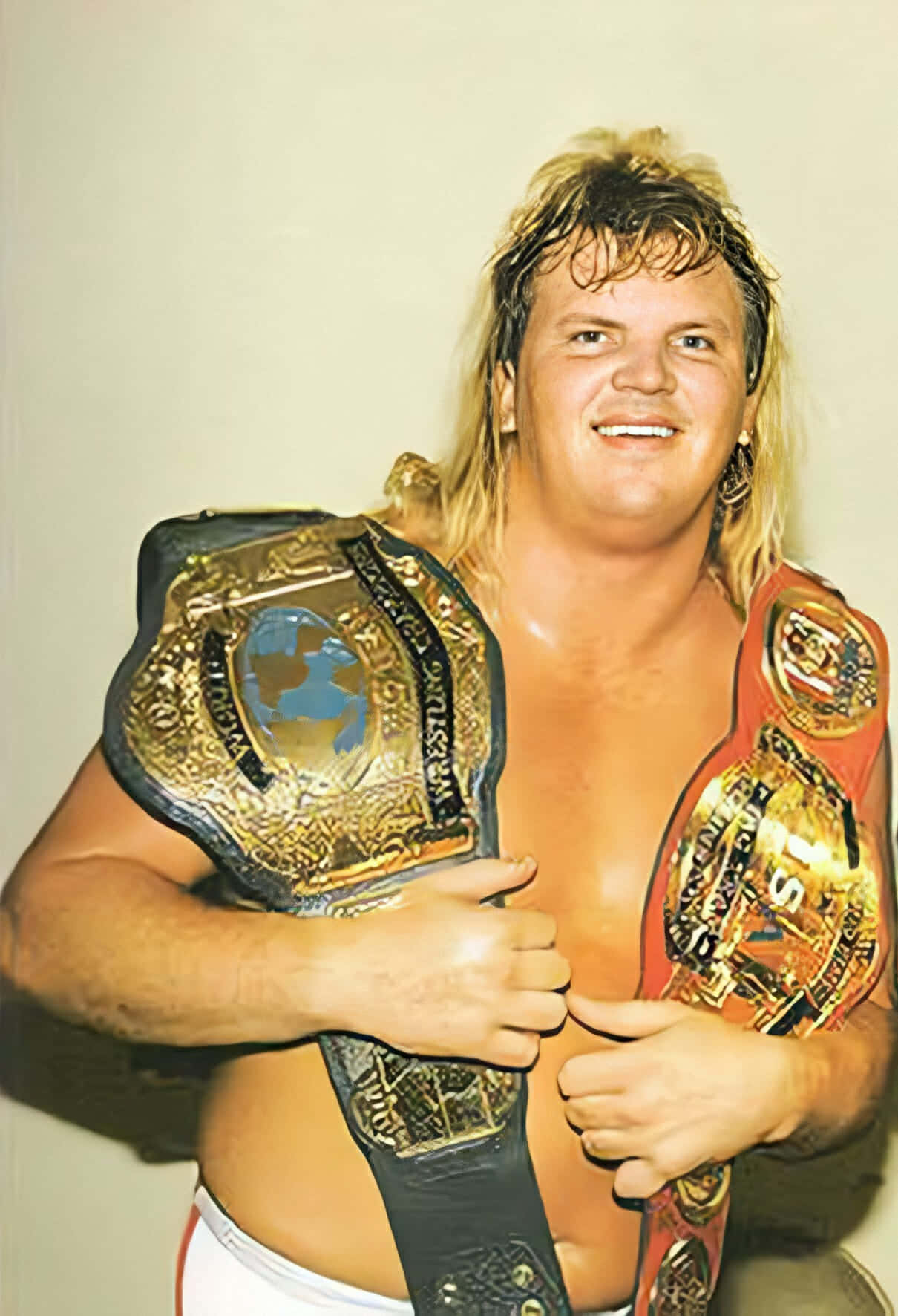 Wrestling Champion Bobby Eaton Holding Two Belts Wallpaper