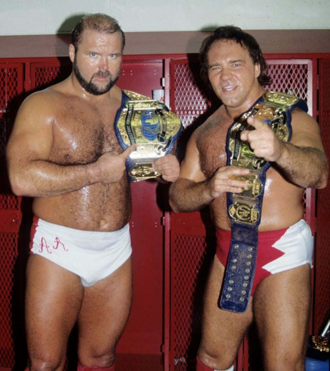 Legendary Wrestlers Larry Zbyszko and Arn Anderson Holding Championship Belts. Wallpaper