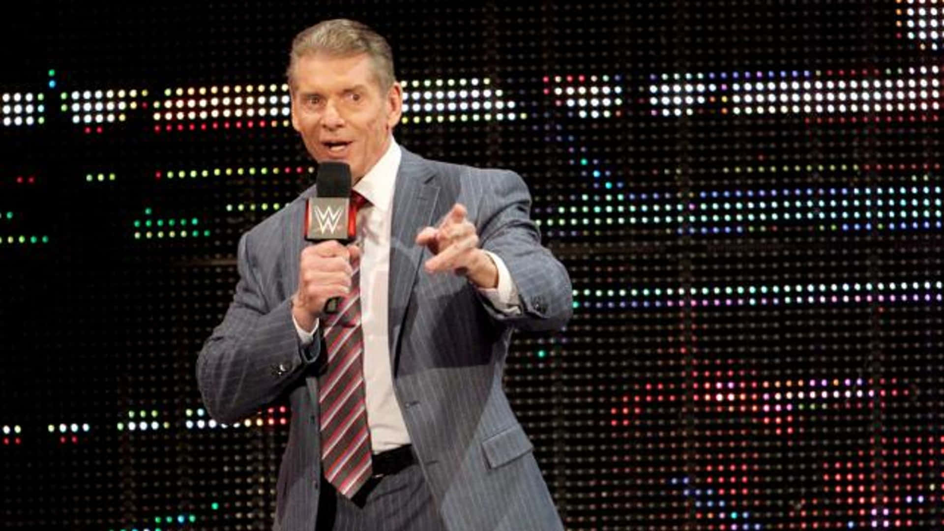 WWE Commentator Vince McMahon Holding A Mic Wallpaper