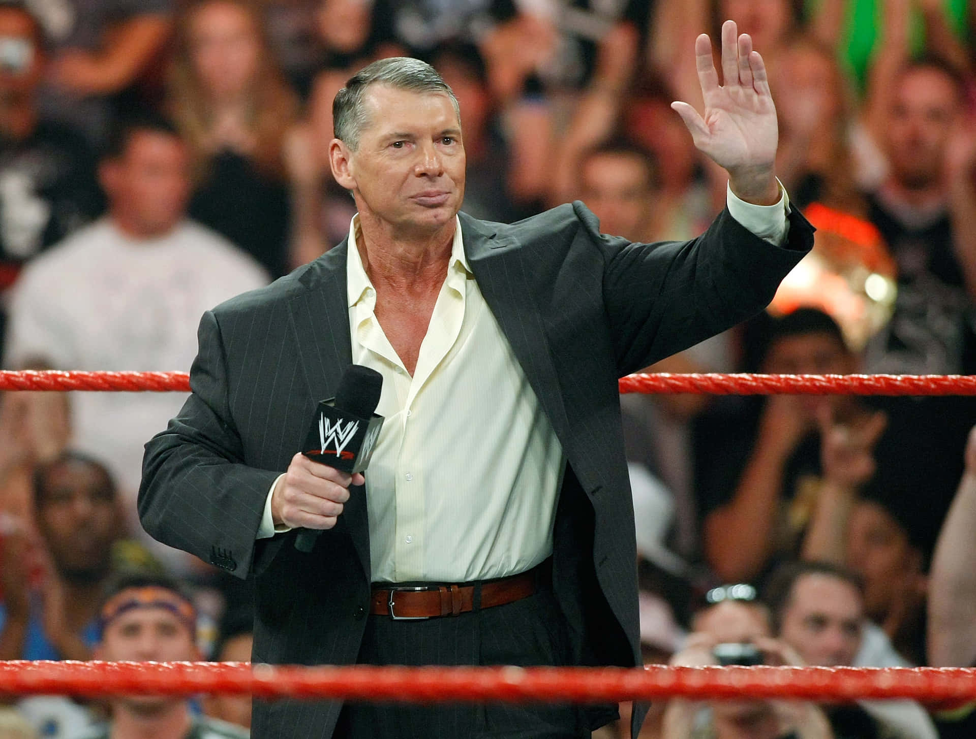 WWE Chairman Vince McMahon joyfully waving at the rapturous audience. Wallpaper