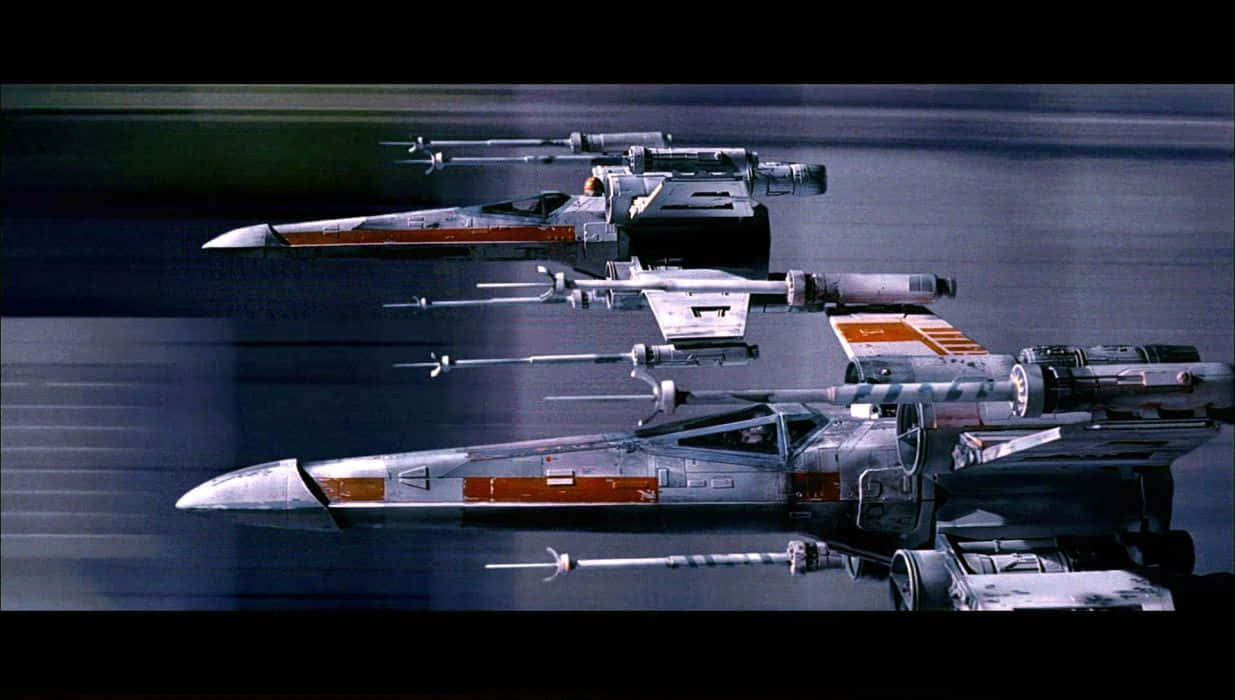 A brave pilot fearlessly flying an X-wing Fighter in the face of danger Wallpaper