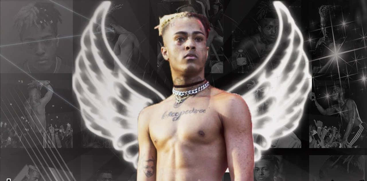 Xxxtentacion Working On His New Music On A Laptop Wallpaper