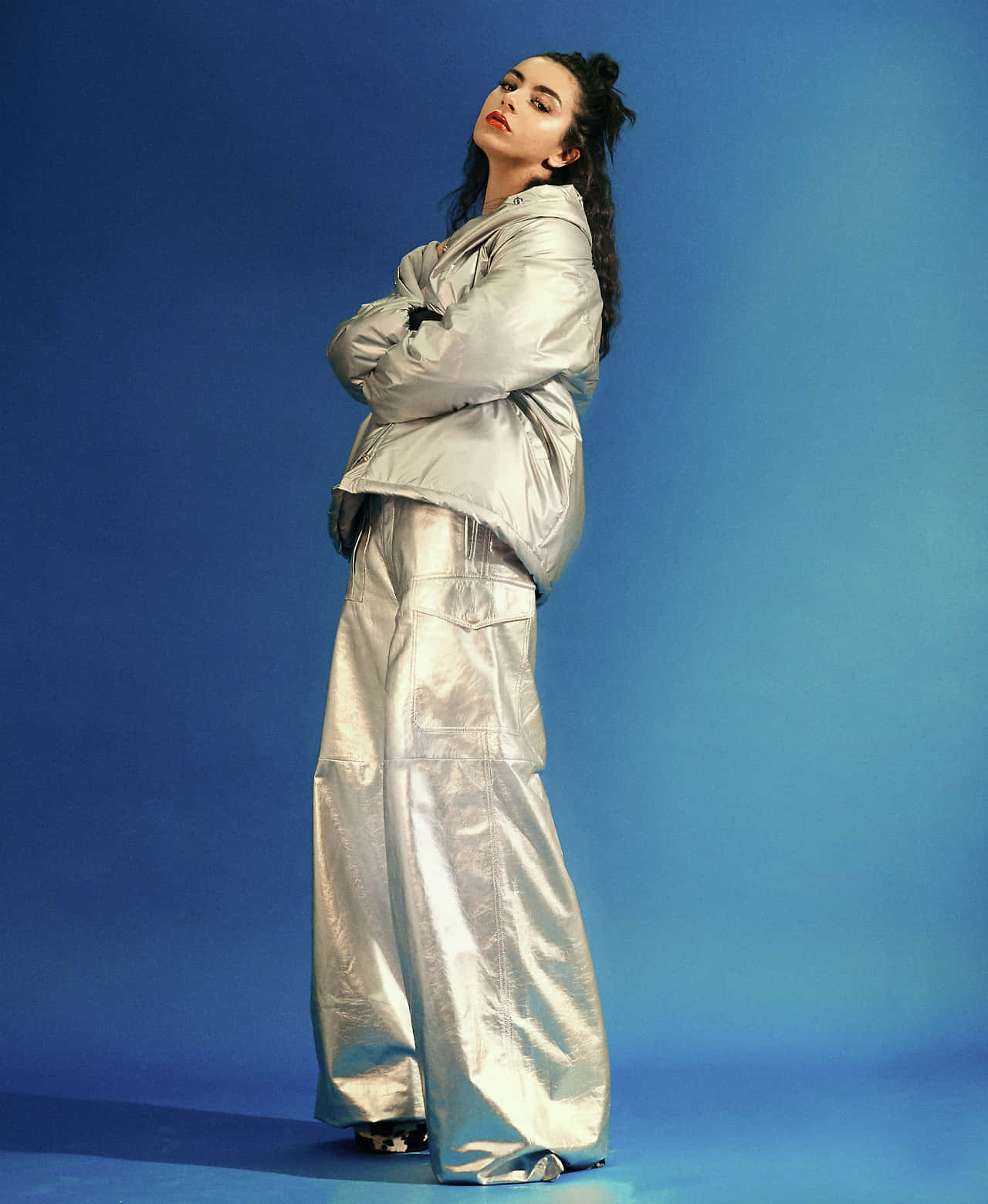 A Woman In A Silver Jacket And Pants