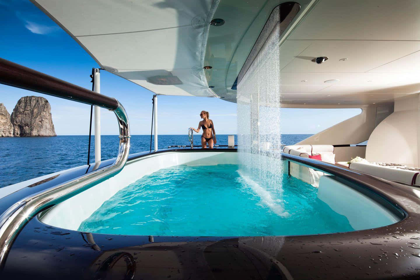 A Woman Standing In The Hot Tub On A Yacht