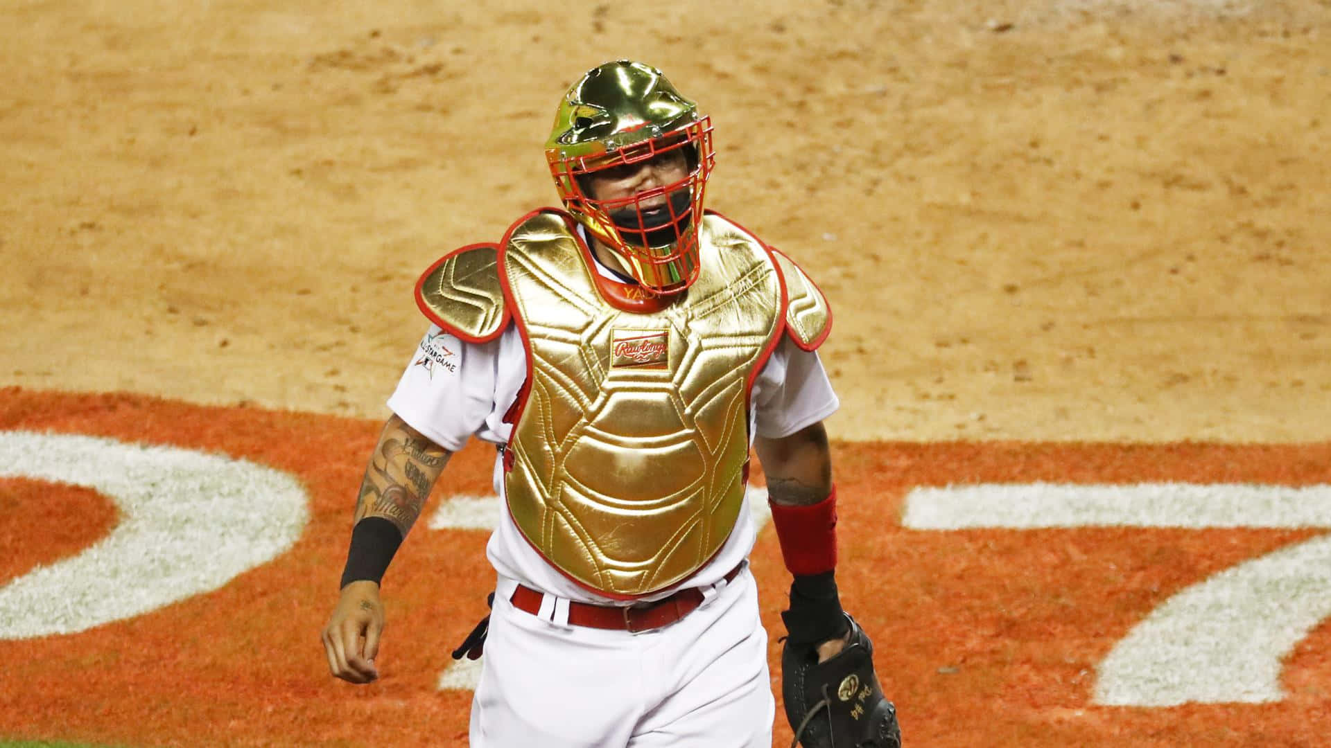 A Baseball Player Wearing A Gold Catchers Mask Wallpaper